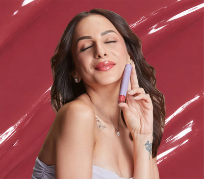 Nitibha Kaul holding ALT+K Beauty Colour Intense Lip Gloss with glossy nude pink lips.