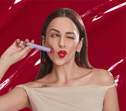 Nitibha Kaul holding ALT+K Beauty Colour Intense Lip Gloss for a high-shine finish.