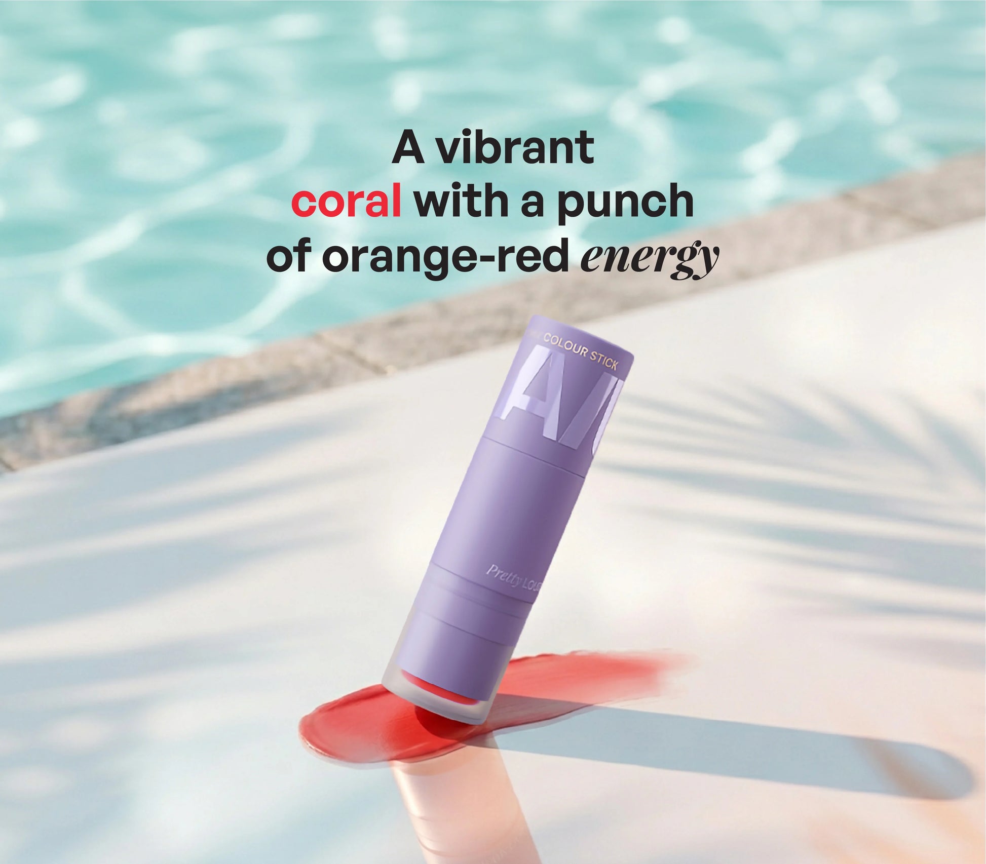 ALT+K Beauty Multipurpose Colour Stick in Pretty Loud coral shade with vibrant orange-red pigment swatch by the poolside