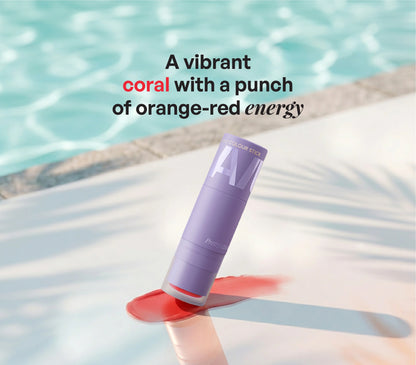 ALT+K Beauty Multipurpose Colour Stick in Pretty Loud coral shade with vibrant orange-red pigment swatch by the poolside